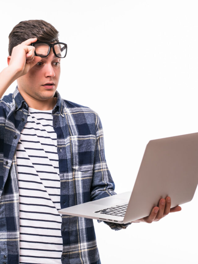 Happy smiling young man watching and working on computer