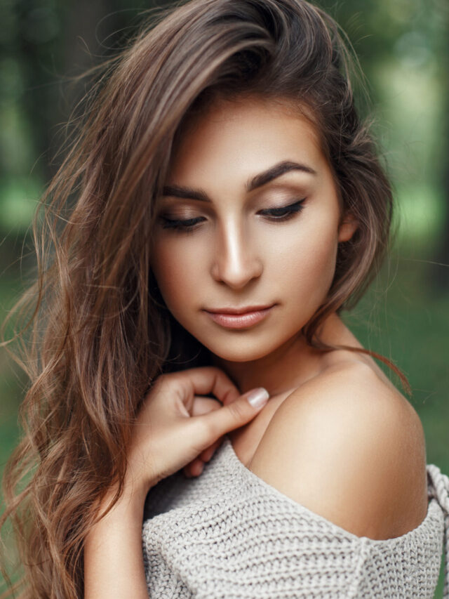 Pretty young girl with the hairstyle in vintage stylish sweater