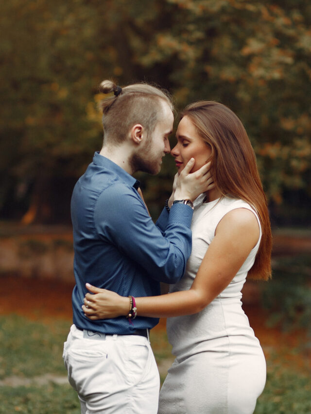 Beautiful couple spend time in a summer park