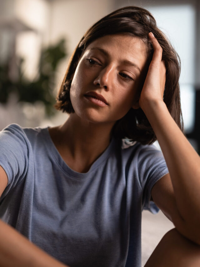 Young sad woman thinking about relationship difficulties she has with her boyfriend.