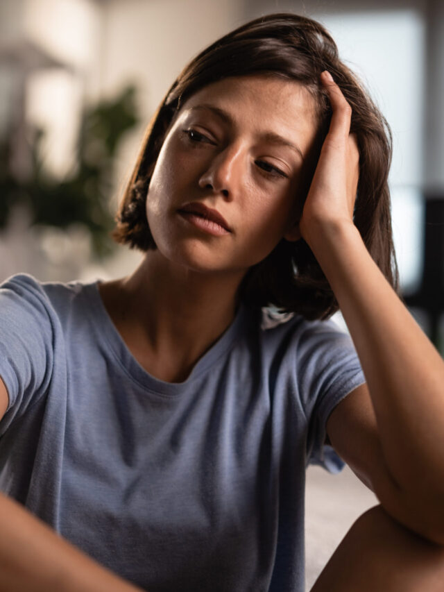 unhappy-woman-contemplating-after-argument-with-her-boyfriend-home-man-is-background